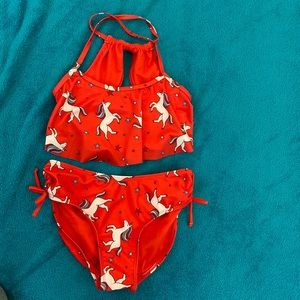 This is a cute red unicorn swimsuit